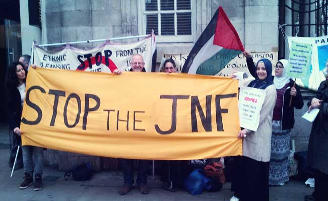 Stop the JNF banner at the protest