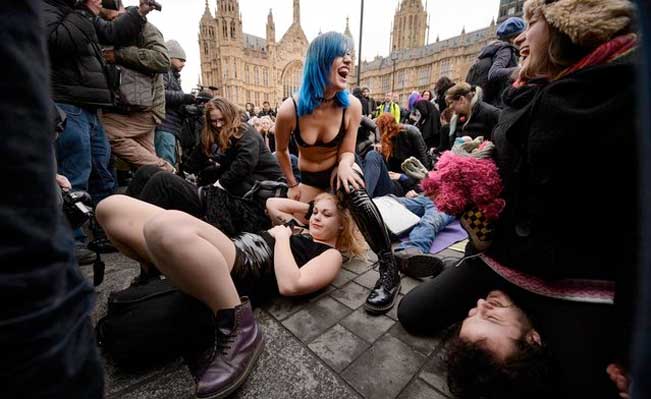 Face-sitting protest outside Parliament. Photo by Leon Neal/AFP Photo