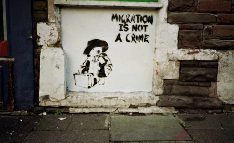 ‘Migration is not a crime’ street art, Cardiff, 2011. Photo: Flickr/Walt Jabsco 