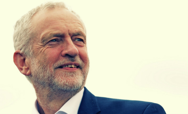 An image of Jeremy Corbyn smiling at a public event