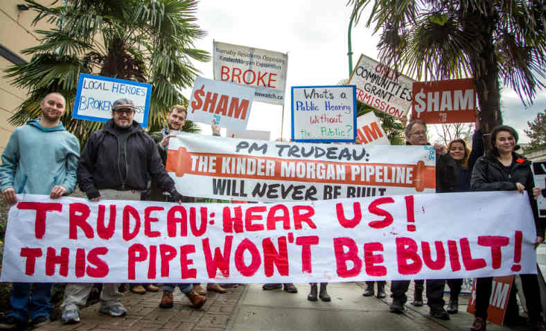 Protesters in the city of Burnaby, British Colombia, hold a banner reading 