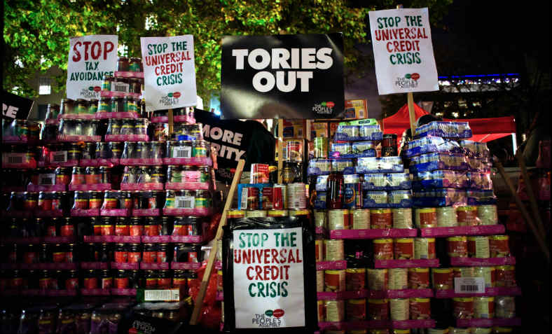 Stacks of canned food donated for foodbanks at the People's Assembly's 'Tories Out' protest demanding an end to the Universal Credit crisis and austerity, outside Downing Street, November 21 2017.