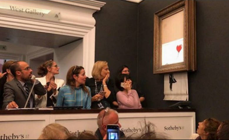 Girl with the Red Balloon shredding after it was sold at auction for over £1m. Photo: Instagram/Banksy