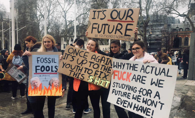 School students with vibrant political placards at the second Youth Strike 4 Climate on Friday in London. Photo: Feyzi Ismail