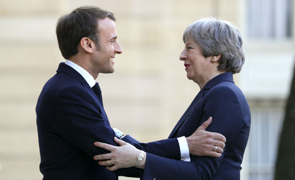 May and Macron embracing