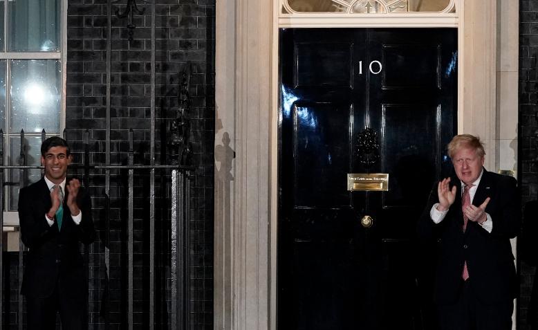 Boris Johnson and Rishi Sunak clapping for carers. Photo: Andrew Parsons / No 10 Downing Street / cropped from original / CC 2.0, linked at bottom of article