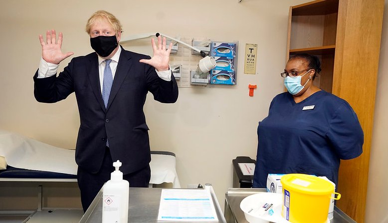 Boris Johnson with a healthcare worker. Photo: Andrew Parsons / No 10 Downing Street /Flickr / cropped from original / licensed under CC 2.0, links at the bottom of article