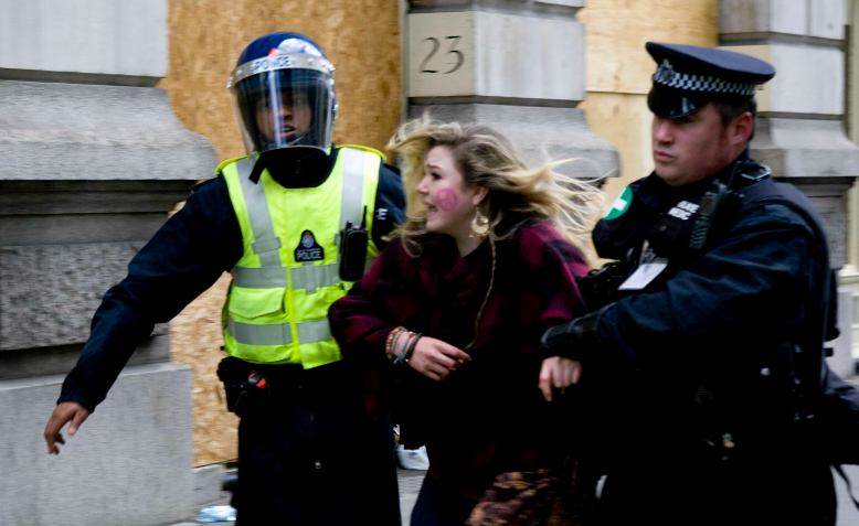 Police arresting woman at the G20 protests, 2009