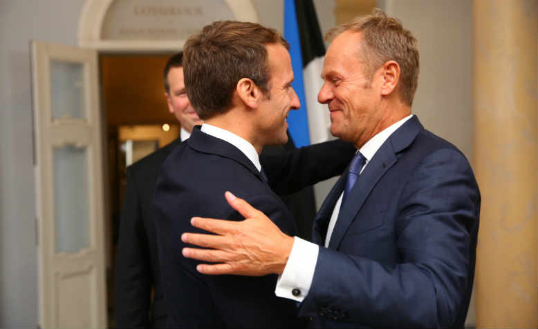 Shady deals: Emmanuel Macron and Donald Tusk embracing in 2017. Photo: Flickr/Arno Mikko