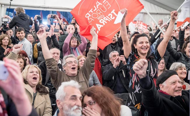 Syriza supporters celebrate after the initial election results in Athens. Photo: EPA