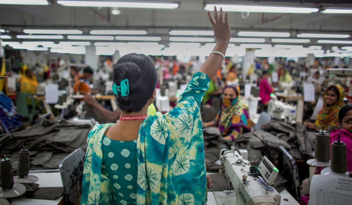 Pushpa Rani Shaha, gives a victory wave to fellow garment workers