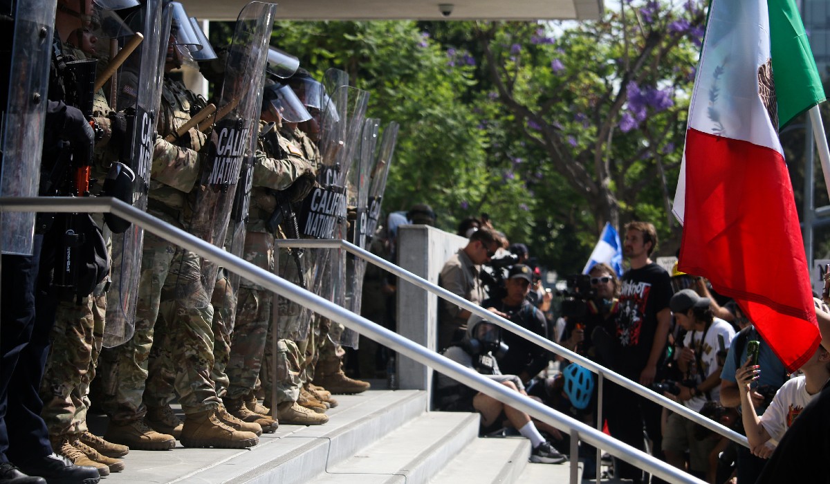 California National Guardsmen stand off against protestors during a demonstration against ICE raids