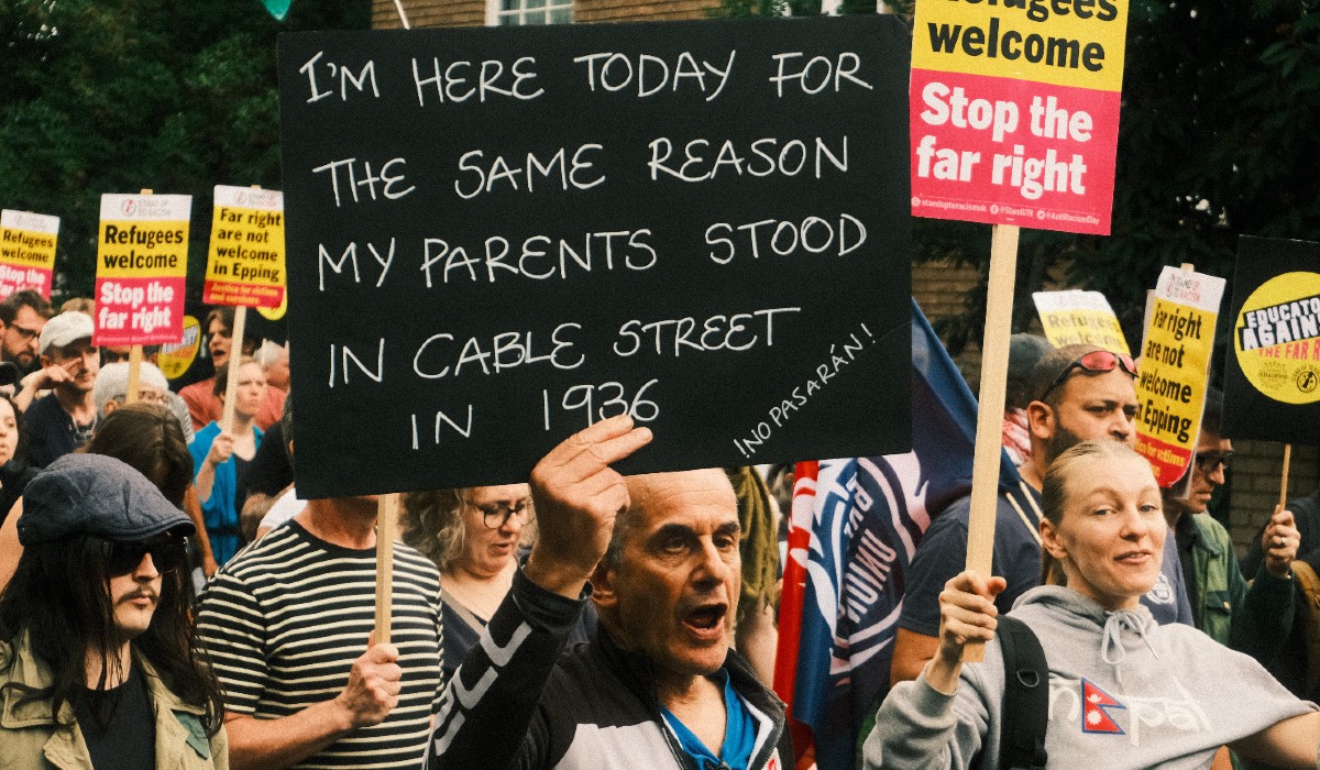 A man holding a placard saying 
