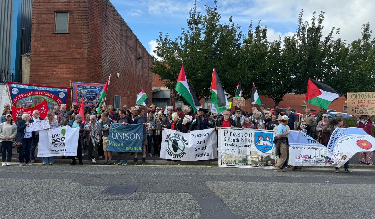 Supporters outside the court with union banners and Palestine flags