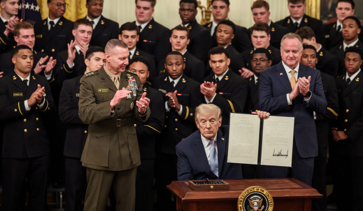 President Donald J. Trump signs an Executive Order during a Commander in Chief Trophy presentation for the U.S. Naval Academy
