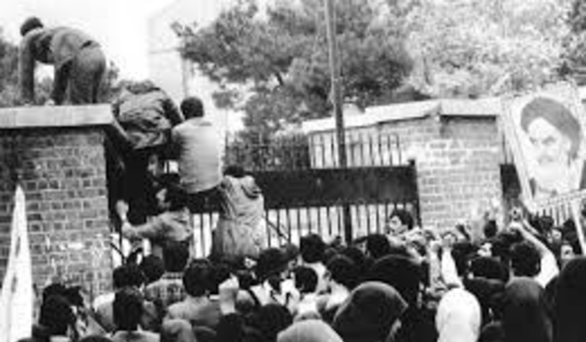 Iranian students climb up U.S. embassy gates in Tehran 04 Nov 1979