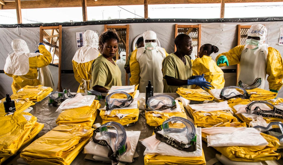 Health workers put their Personal Protective Equipment on before entering the zone where people are quarantined. 2019 Beni, DR Congo